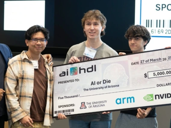 Four students from the team AI or Die hold and oversized check. 
