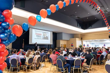 homecoming attendees in grand ballroom, balloon decorations