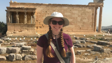 MSE grad student Madison Sitkiewicz poses for a picture in front of Grecian ruins