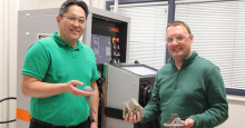 Sammy Tin, left, holds metal 3D-printed hip replacement parts. Andrew Wessman holds metal 3D-printed jet engine parts.