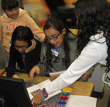 Girl power! A group of Mansfeld Middle School students puts together a circuit board during UA Science Day 2013.