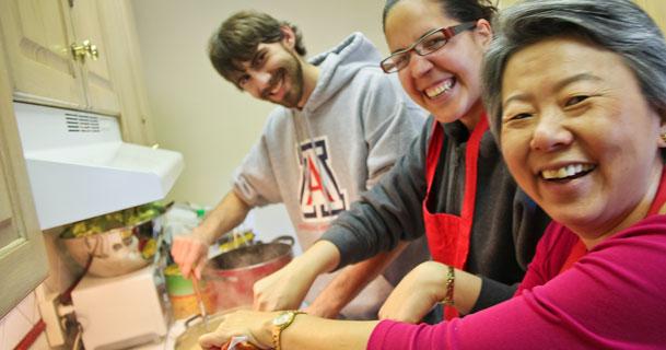Professor Supapan Seraphin, right, and some of her students have some fun in the kitchen preparing vast quantities of Thai curry for hungry students. (Pete Brown/UA Engineering)