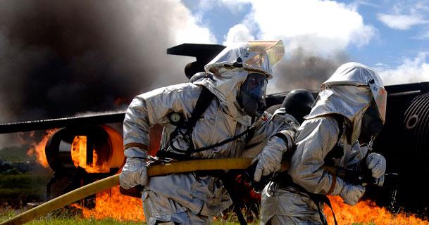 Firefighters work to put out a fire as part of a simulated aircraft crash during an exercise at Anderson Air Force Base in Guam. The routine exercise is conducted at the base a few times a year to sharpen the mobility and wartime capabilities of participating service members. (U.S. Air Force photo by Staff Sgt. Bennie J. Davis III)